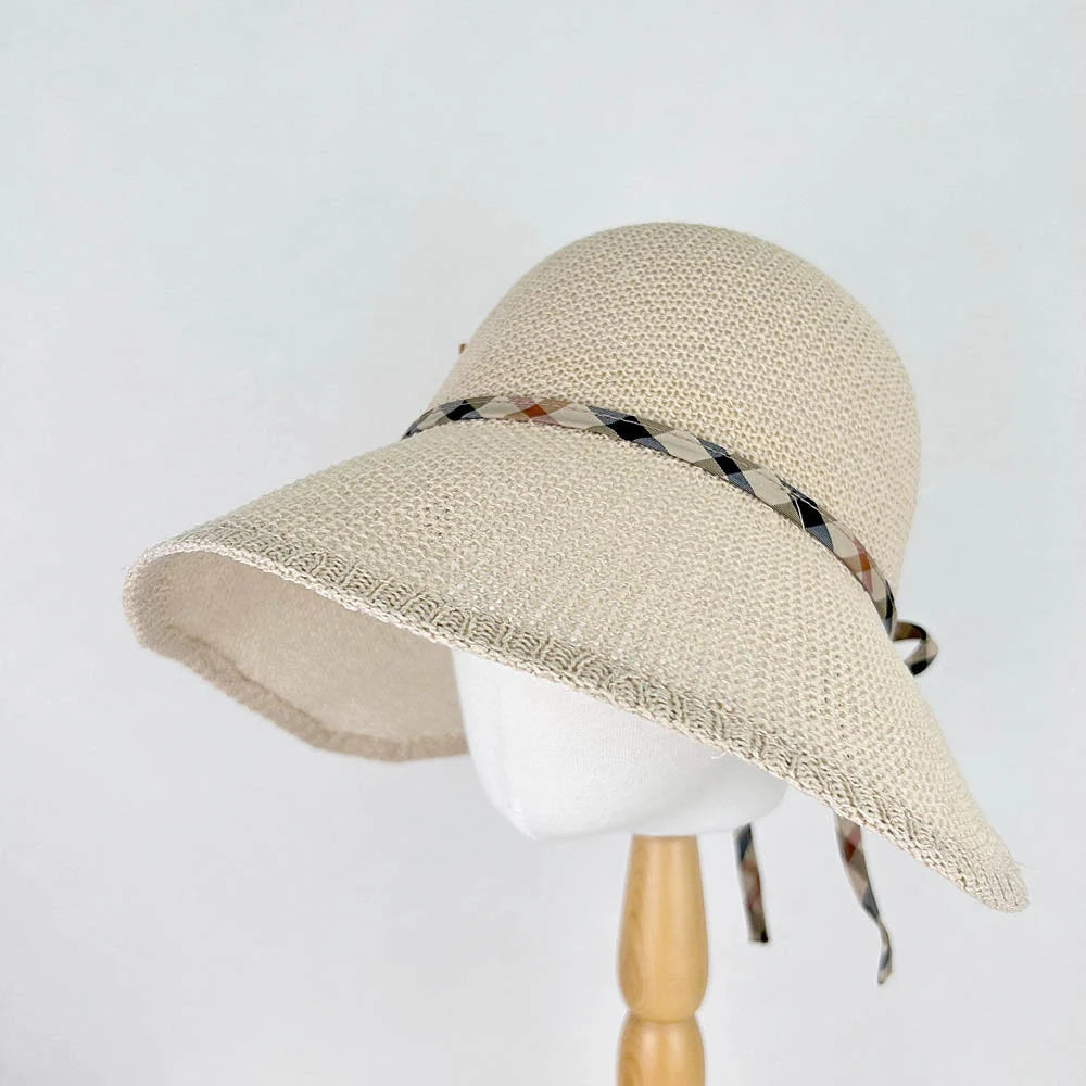kelly's picnic beige sun hat with a wide brim, adorned with a stylish plaid ribbon—perfect women's hat for summer or beach