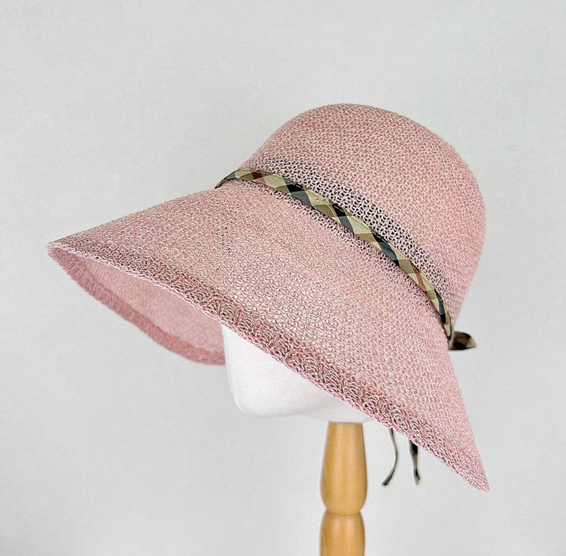 Pink woven sun hat, a kelly's picnic design, featuring a wide brim and decorative patterned ribbon