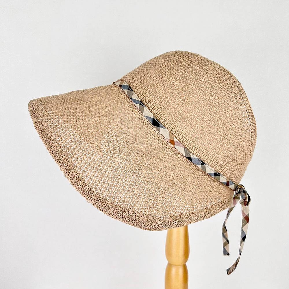 kelly's picnic beige straw sun hat with wide brim for sun protection, accented by a stylish plaid ribbon tie. A perfect summer hat for women, with an adjustable fit.