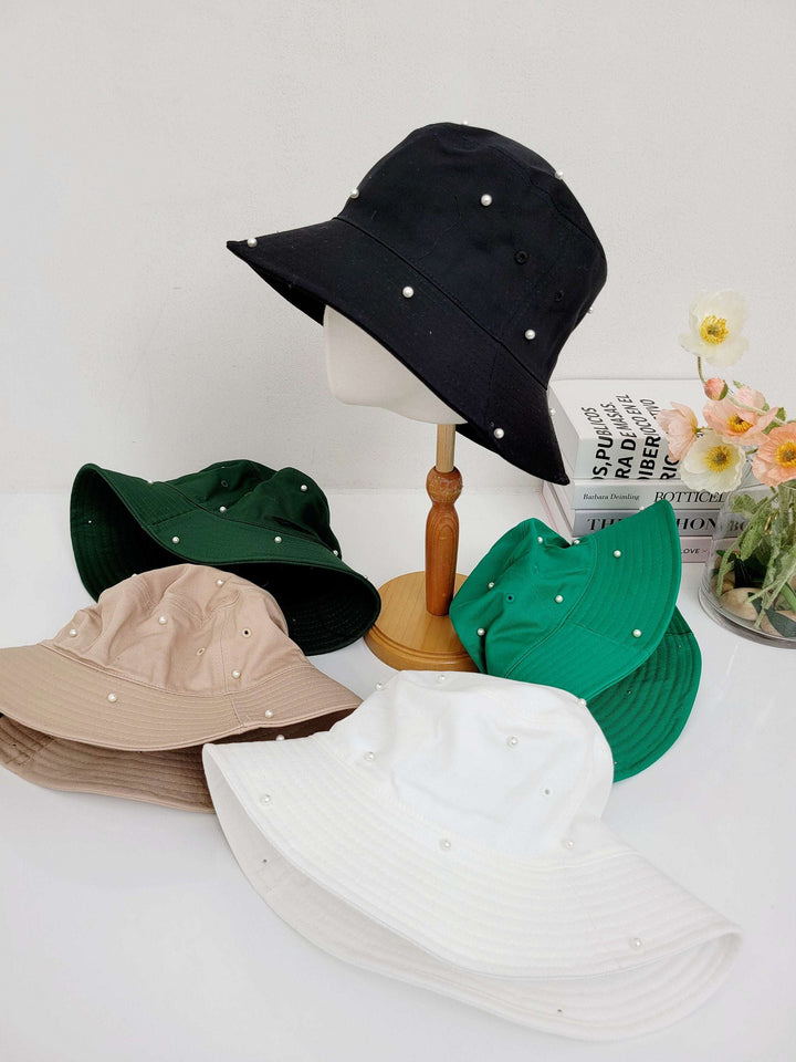 cotton bucket hat-pearl: Assorted colors (black, green, beige, white) each with pearl details. Stylish sun protection.