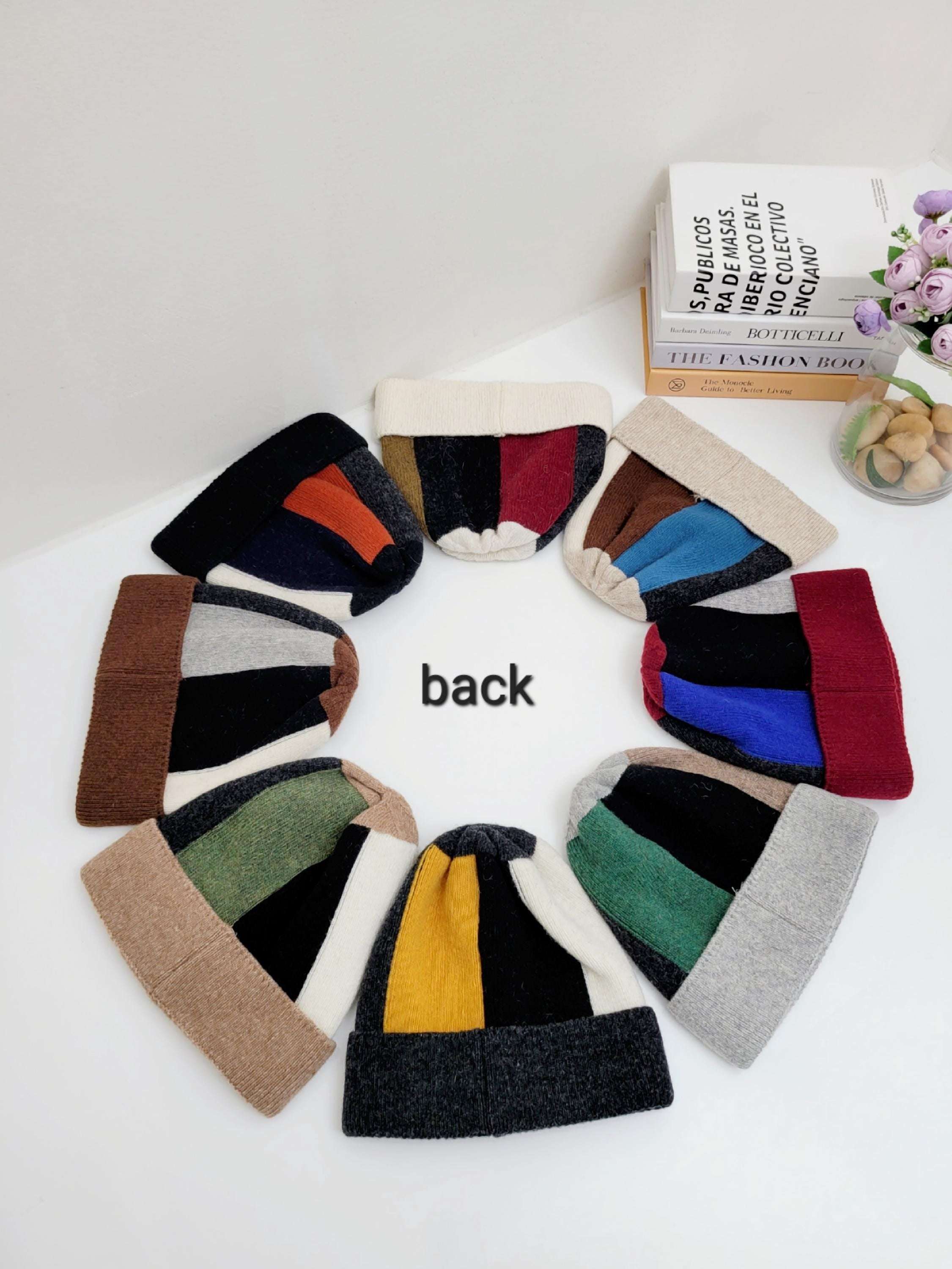 Color block wool beanie collection; an array of beanies in diverse color combinations arranged in a circle.