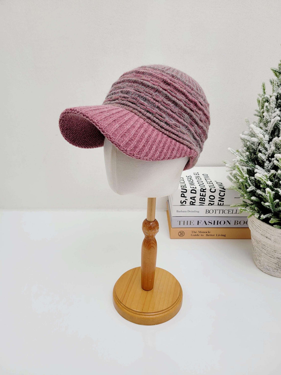 clara winter cap: mauve and gray knit cap with a short brim, displayed on a mannequin head, perfect for winter warmth and style.