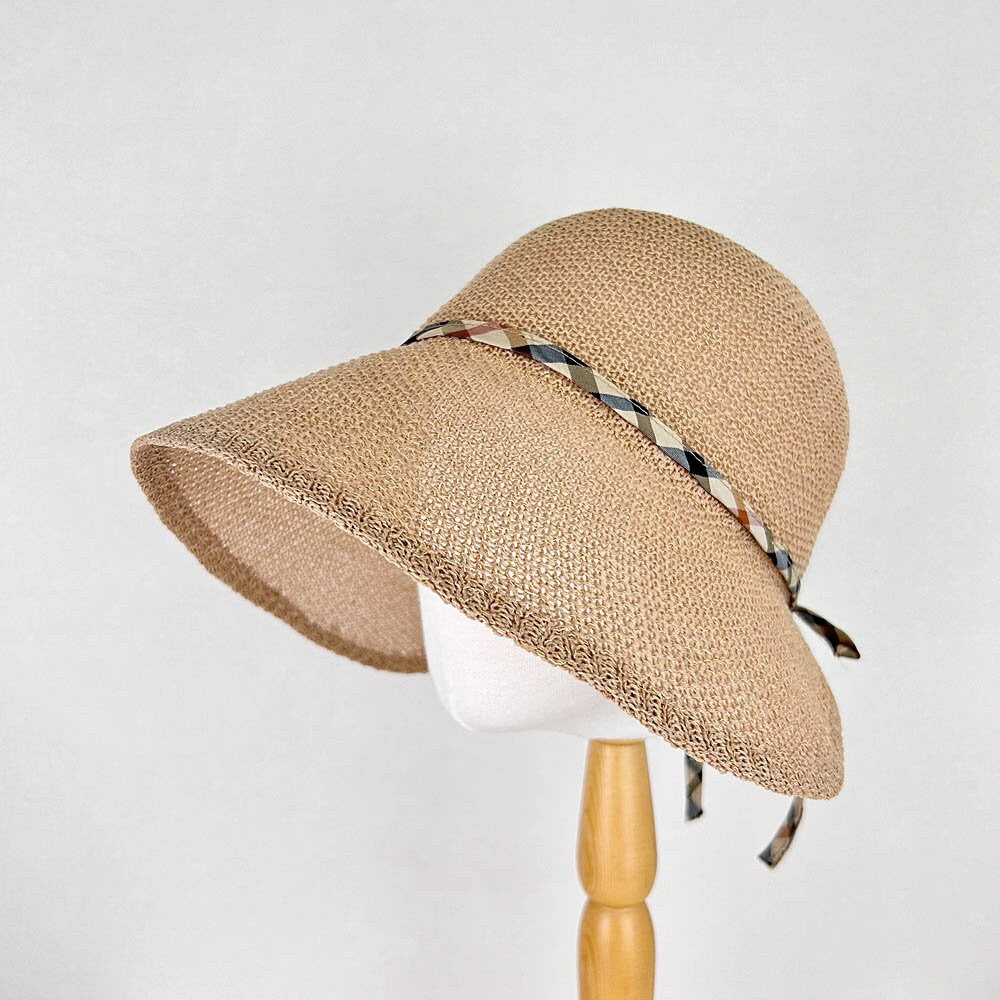 kelly's picnic: Beige woven summer hat with a wide brim for sun protection, accented by a stylish plaid ribbon