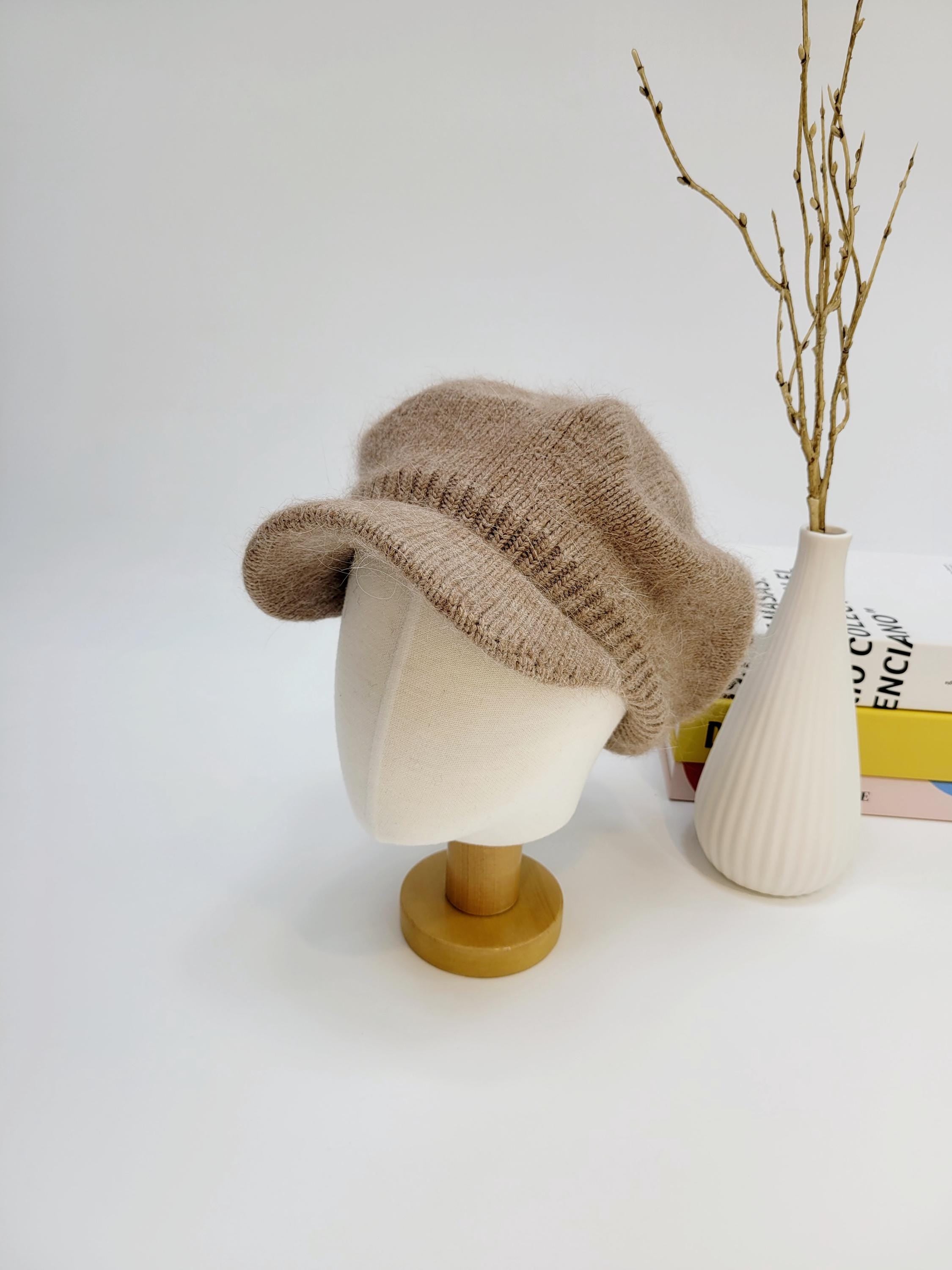 Beige knit angelina in love hat on a mannequin head. Soft, textured knit with a slightly floppy brim.