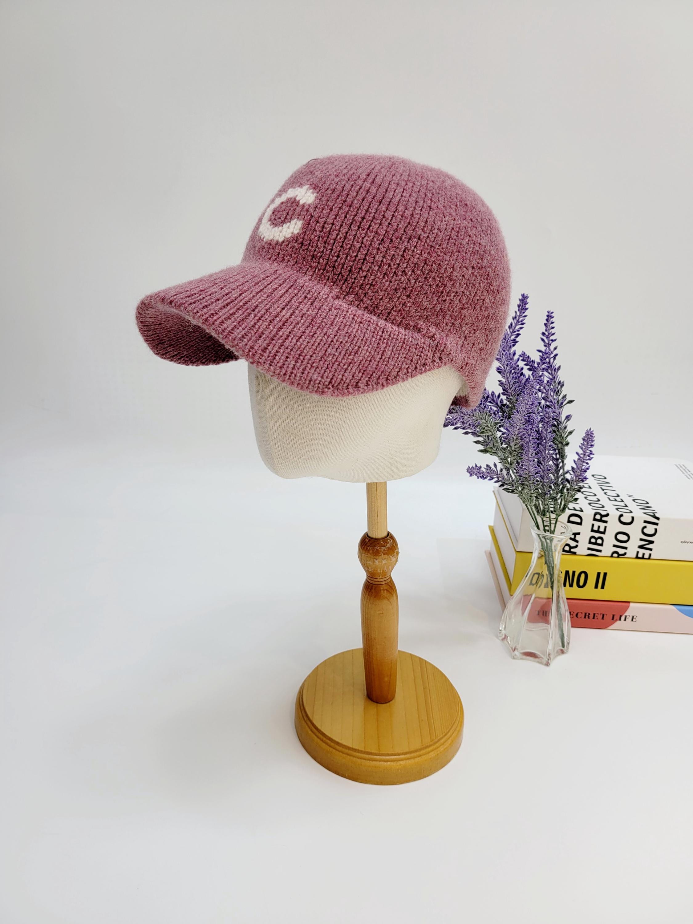Mauve knit c-wool cap with a white "C" on the front, stylish and warm for cooler weather