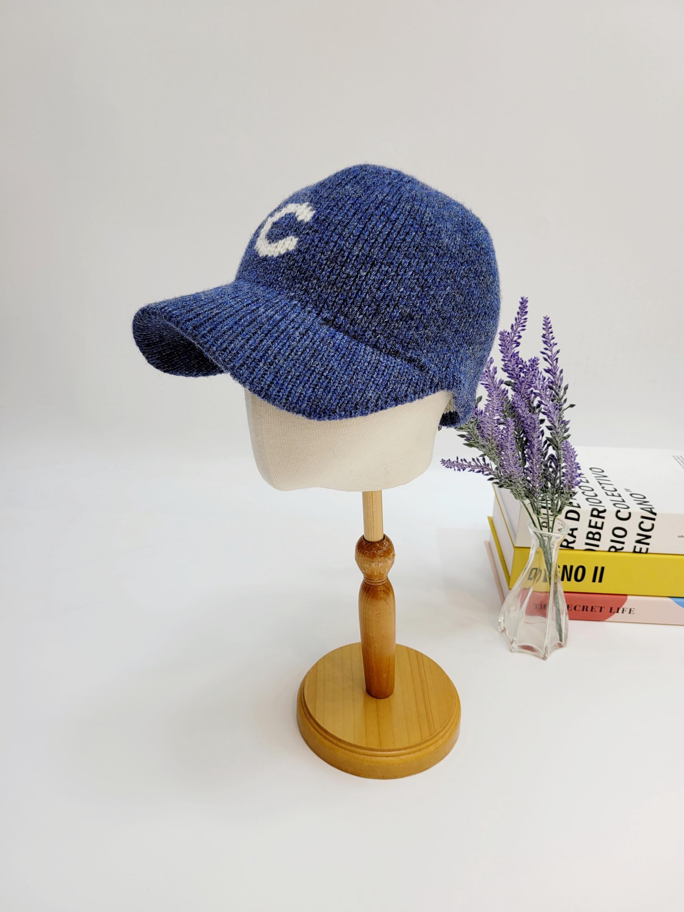 Blue knit c-wool cap with a white "C" on the front, perfect for casual wear.