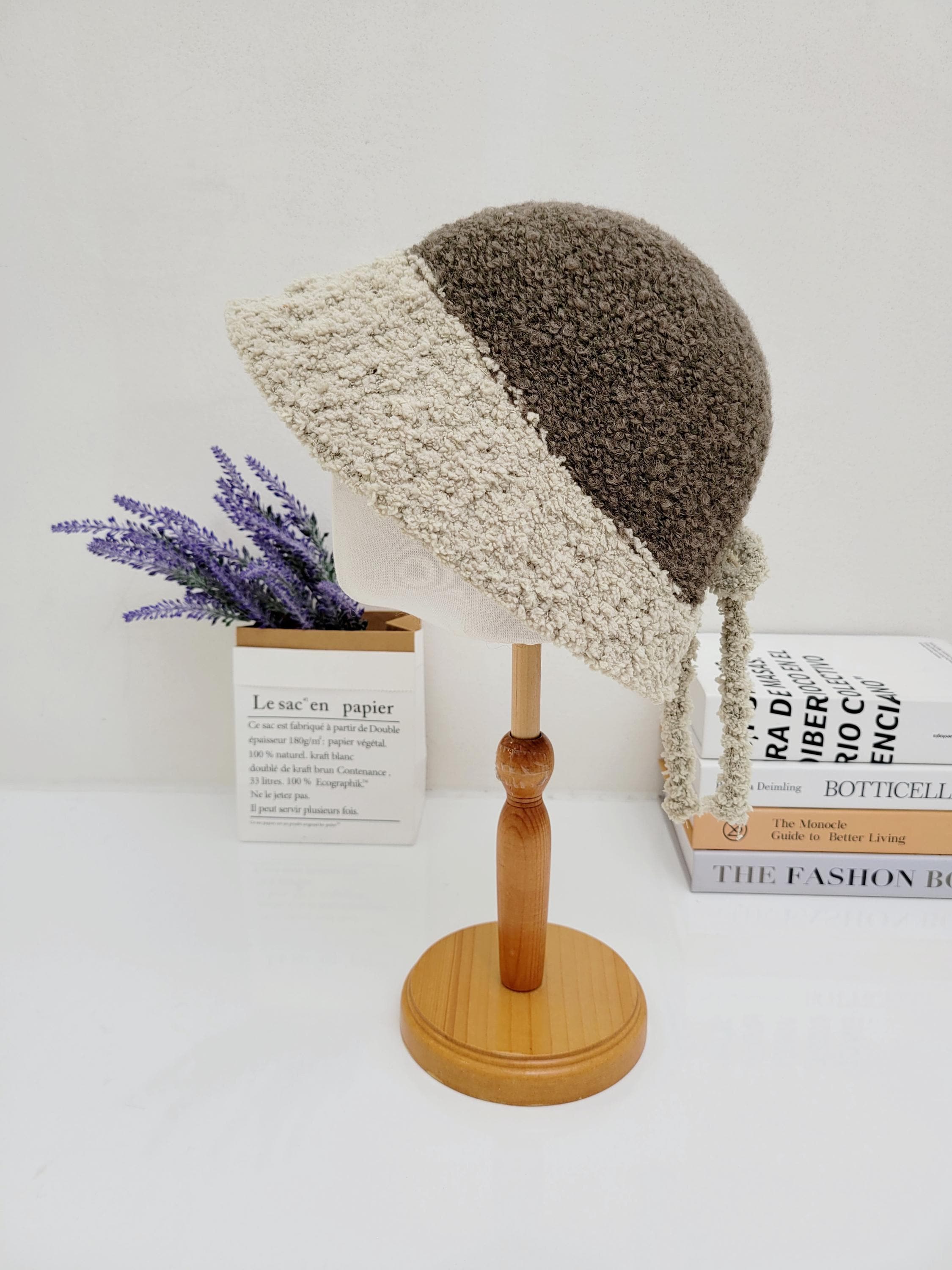 boho bucket - sherpa hat in brown and cream, displayed on a wooden stand with a soft, textured sherpa finish