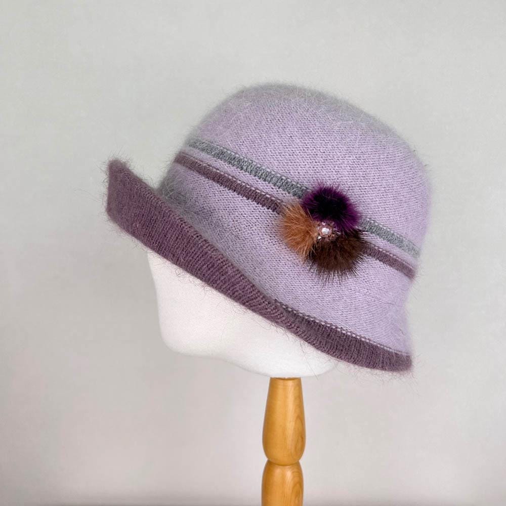 Light purple angora elizabeth hat with a dark purple brim, striped band, and decorative pompom detail.
